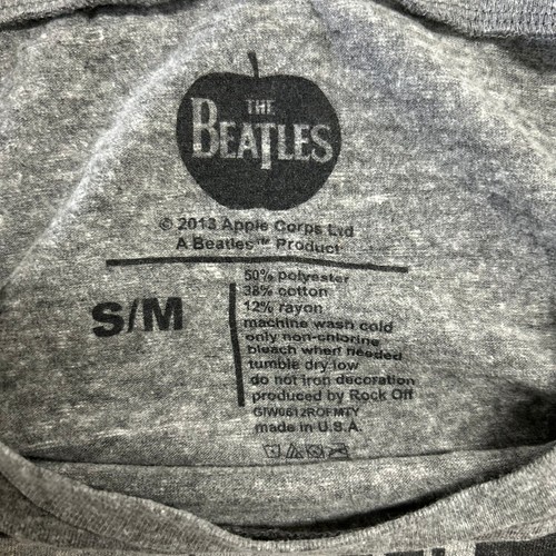 Grey cropped T-shirt with white “THE BEATLES” logo, size S/M, and product details in black text.
