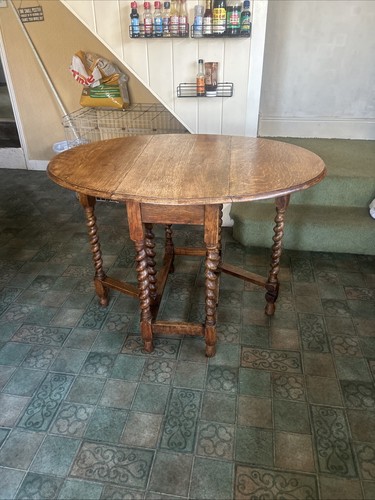 This is an antique oak gateleg drop-leaf table with barley twist legs ...