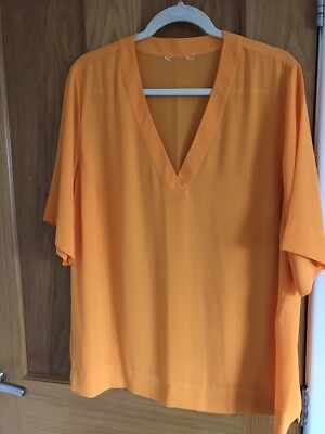 Ladies Orange Deep Veck Neck Chiffon Top With Hem Side Spilt
