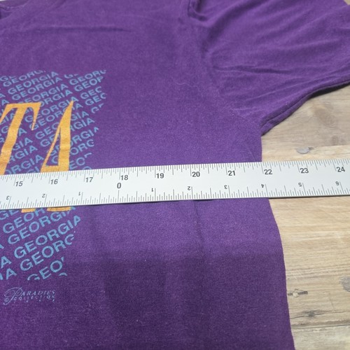 Purple vintage ATLANTA GEORGIA T-shirt with orange block lettering and white measuring tape across the chest.