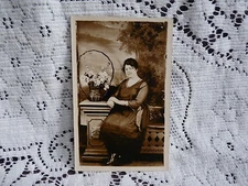 RPPC Early 1900's  Woman sitting on bench/basket flowers/Western Studios/Indiana