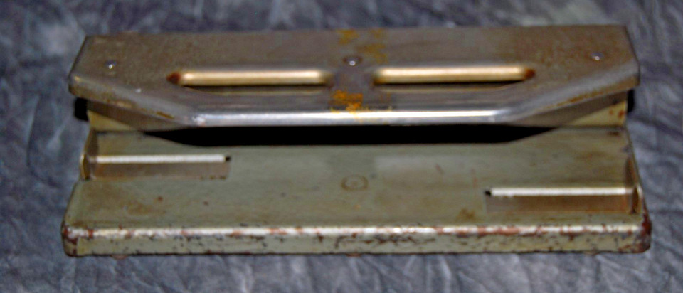 A beefy mid-century all-metal adjustable 3-hole punch built like a tank — this thing will outlive everyone in your office.