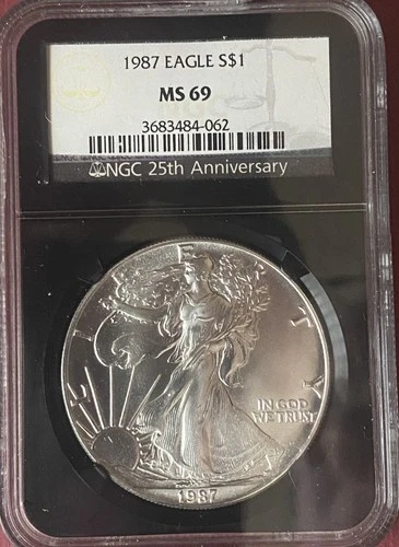 1987 SILVER EAGLE NGC MS69 HGC 25TH ANNIVERSARY HOLDER - BLACK HOLDER