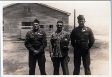 WW2 Photo of Three Soldiers Standing in Front of Wooden Barracks
