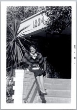 Vtg Snapshot Smiling Woman in Fur Stole Sitting On Brick Wall 1234 House 1964