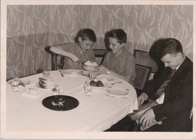 1961 Photo of Two Boys Dining With Man At Round Table After Meal