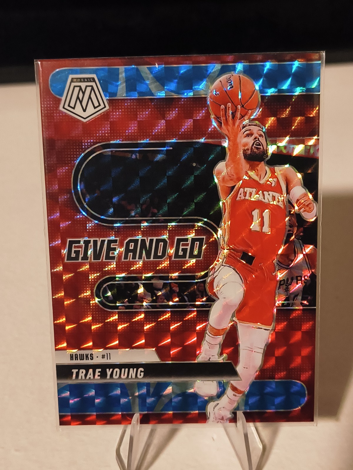2024-25 Panini Mosaic - Give and Go Trae Young #8 Reactive Blue Mosaic Prizm /99