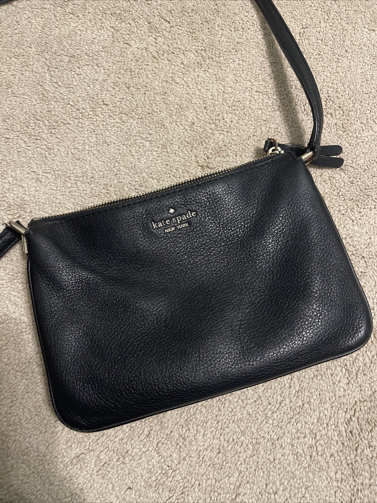 Kate Spade black leather crossbody bag with gold accents  