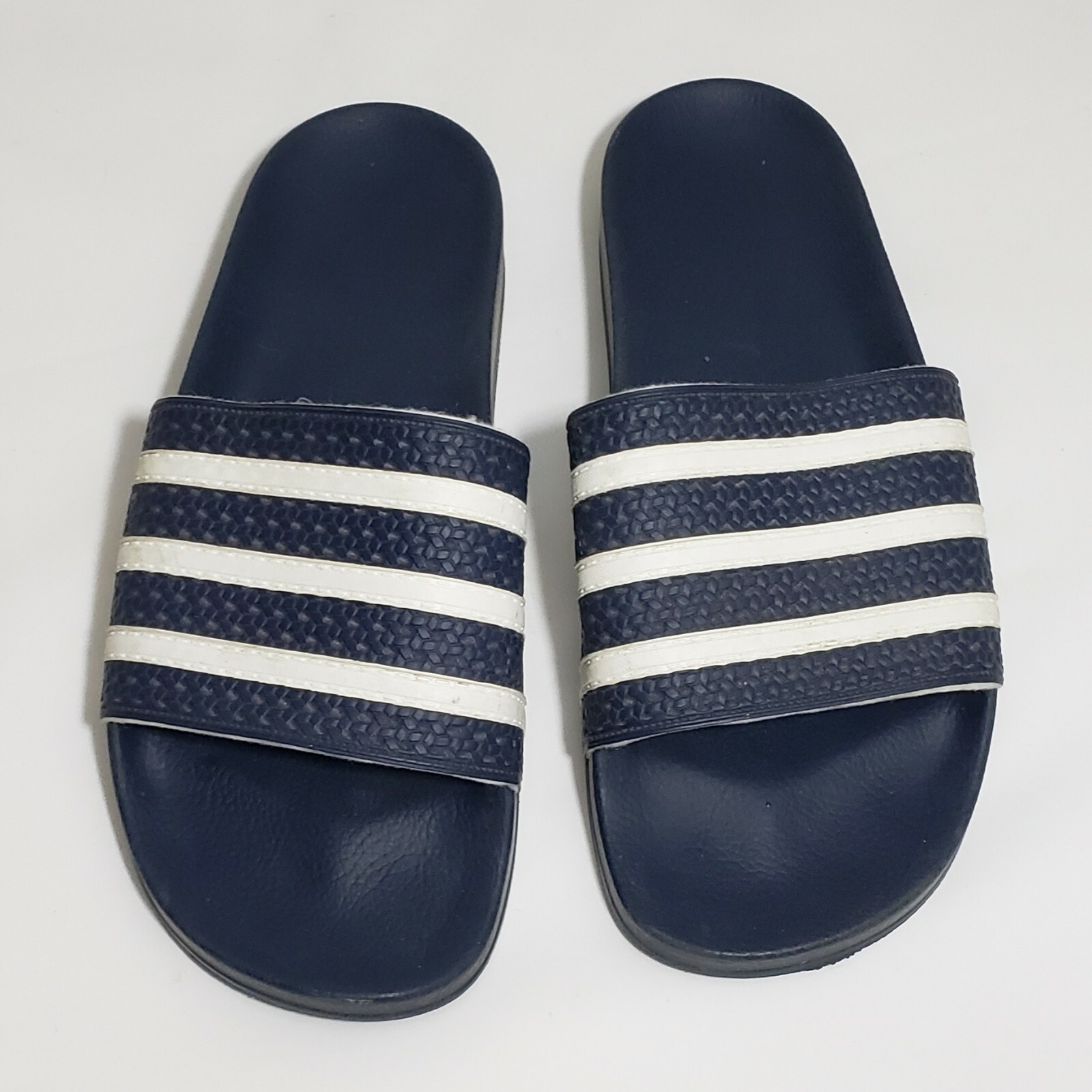 dark blue adidas slides