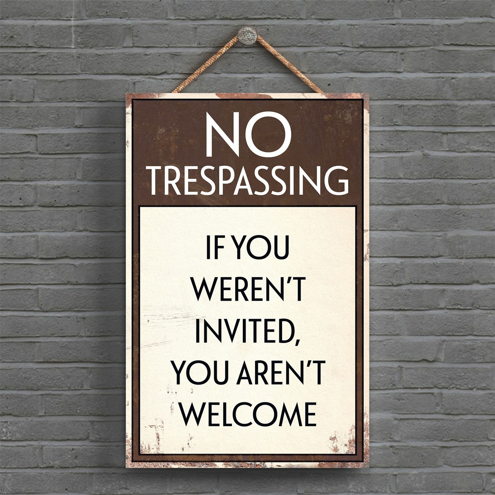 NO TRESPASSING YOU WEREN'T INVITED TYPOGRAPHY SIGN PRINTED ONTO A PLAQUE