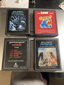 Lot 4 Atari 2600 Cartridges Asteroids, Q-bert, Combat, and Defender