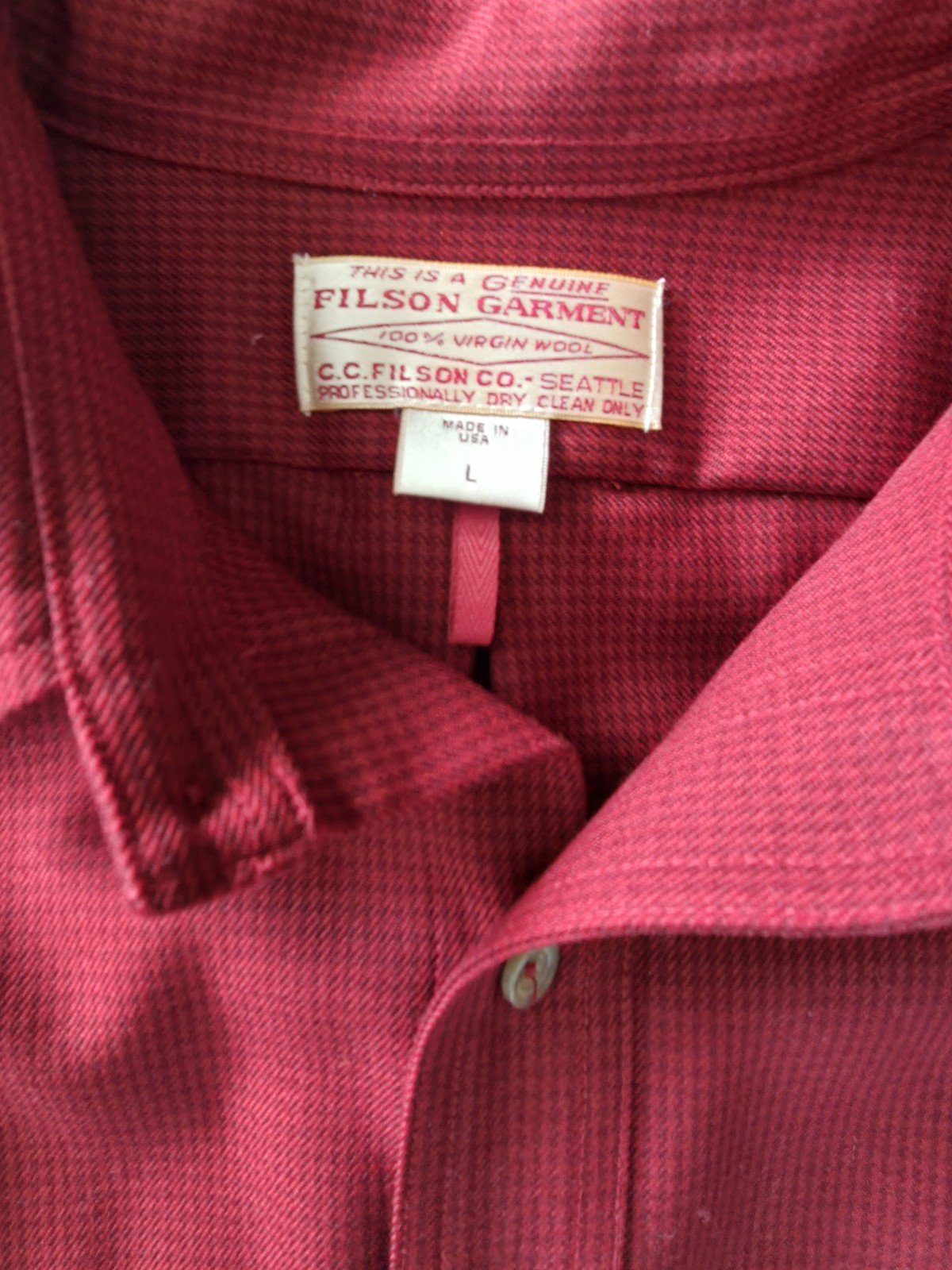 Red Filson Virgin Wool shirt, size L, with white label showing company name and “Made in USA” text.