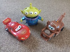 Disney figures. LIghtning mcqueen, Toy story 3 alien and Tow mater