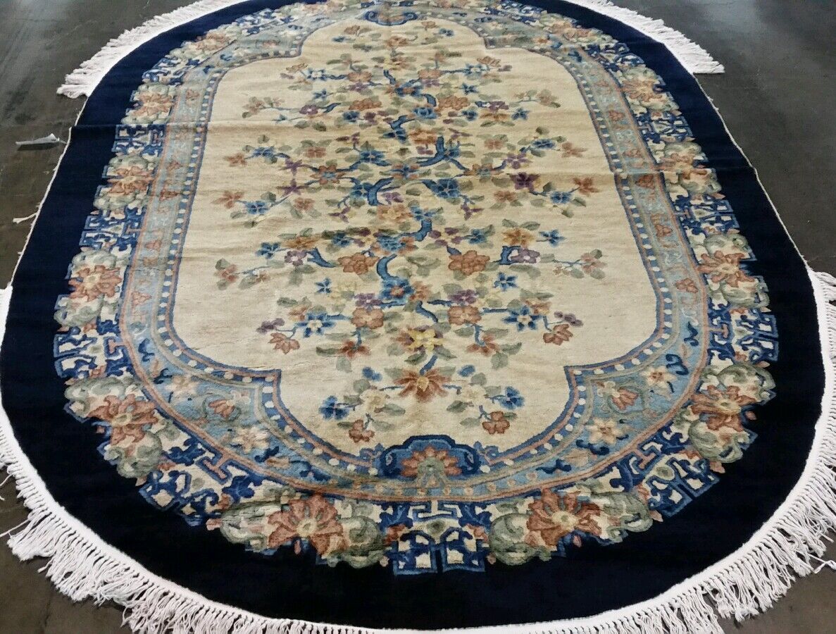 AN OVAL CHINESE RUG