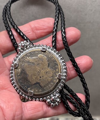 Pre-Owned Dark Toned 1886 Morgan Dollar Black Leather Bolo Tie, 36 In. 65 Gr.