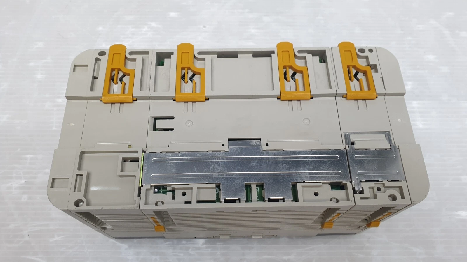 Omron CQM1H assembly showing the orange DIN-track latches and module connectors