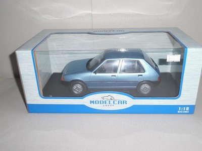 MODELLAUTOGRUPPE. MCG 18491. `PEUGEOT 205 HELLBLAU METALLIC 2024``. Maßstab 1:18