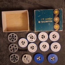 13 empty film reels for 8mm camera that are 3" in diameter. Plus vintage box