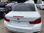 White 2018 BMW 430I rear door mirror with red BMW logo, blue handwritten text, and visible paint scratches.
