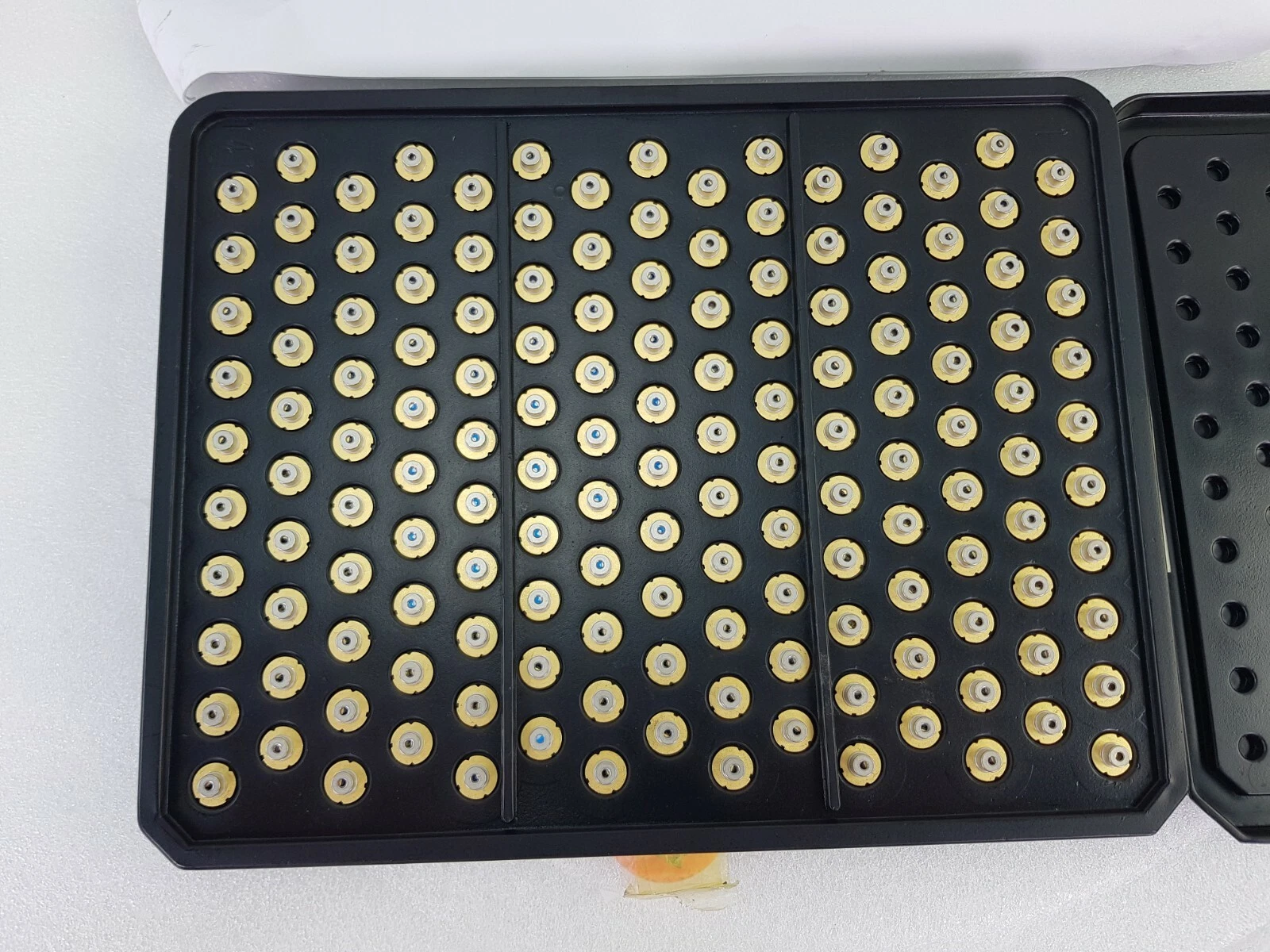 Close view of the black tray holding HL6312G 9 mm laser diodes