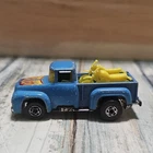 Vintage Hot Wheels 1973 Hi-Tail Hauler '56 Ford Pickup with yellow motorcycles.