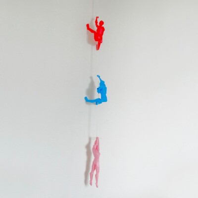 Colorful Polygonal Climbing Wall Sculptures - Red, Blue, and Pink Figures