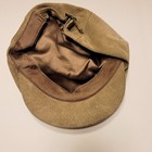 Tan suede leather newsboy cap with unbranded fabric interior, long ears, and adjustable strap.