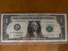 US dollar with one serial number lighter than the other ink contamination error