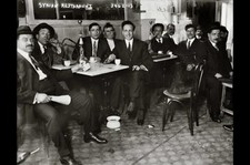 Syrian restaurant,men seated around tables,playing cards,smoking hookah