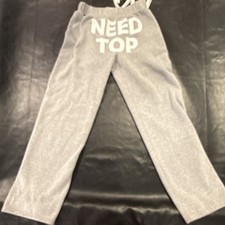 Comfortable and stylish gray sweatpants featuring a bold NEED TOP graphic.