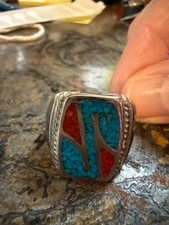 This is a vintage Native American Navajo sterling silver ring with a turquoise a