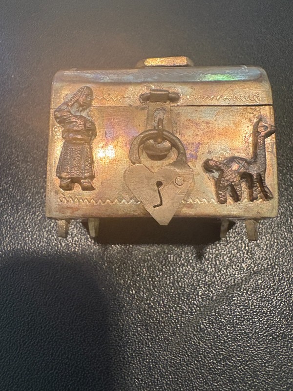Miniature Peruvian silver chest, 5 indigenous designs attached with lock. 1.5" W