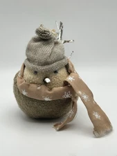 Winter Bird Figure Sitting With Hat Scarf And Twig Tail Feathers