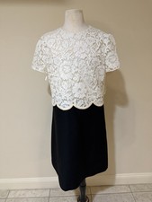 Italian-made luxury dress featuring, cream lace overlay bodice and black skirt.