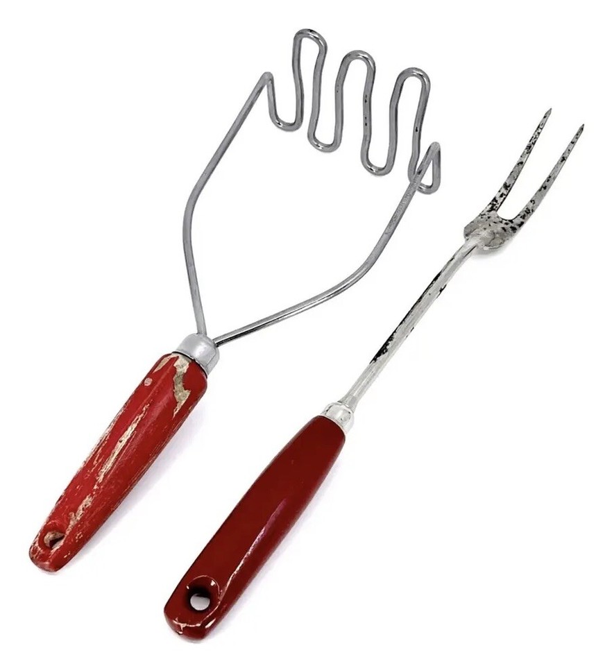 A curated set of stainless and red-wood-handled MCM kitchen tools — the red + steel combo is a classic American farmhouse look that photographs beautifully.