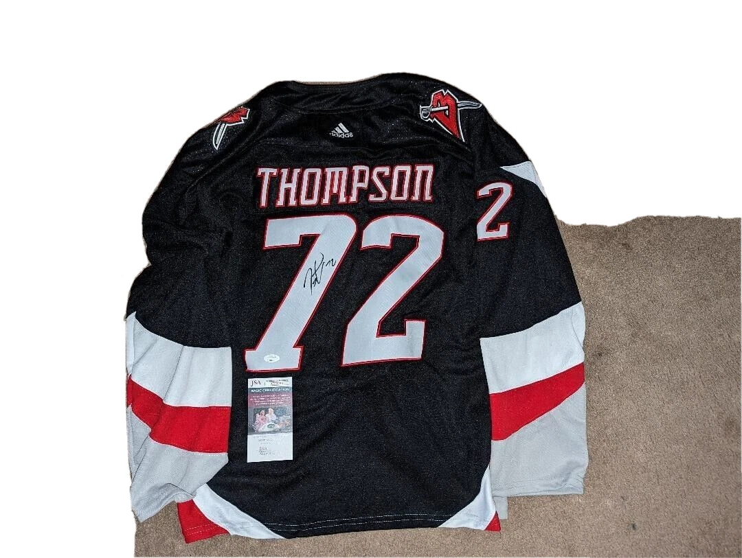 tage thompson black jersey