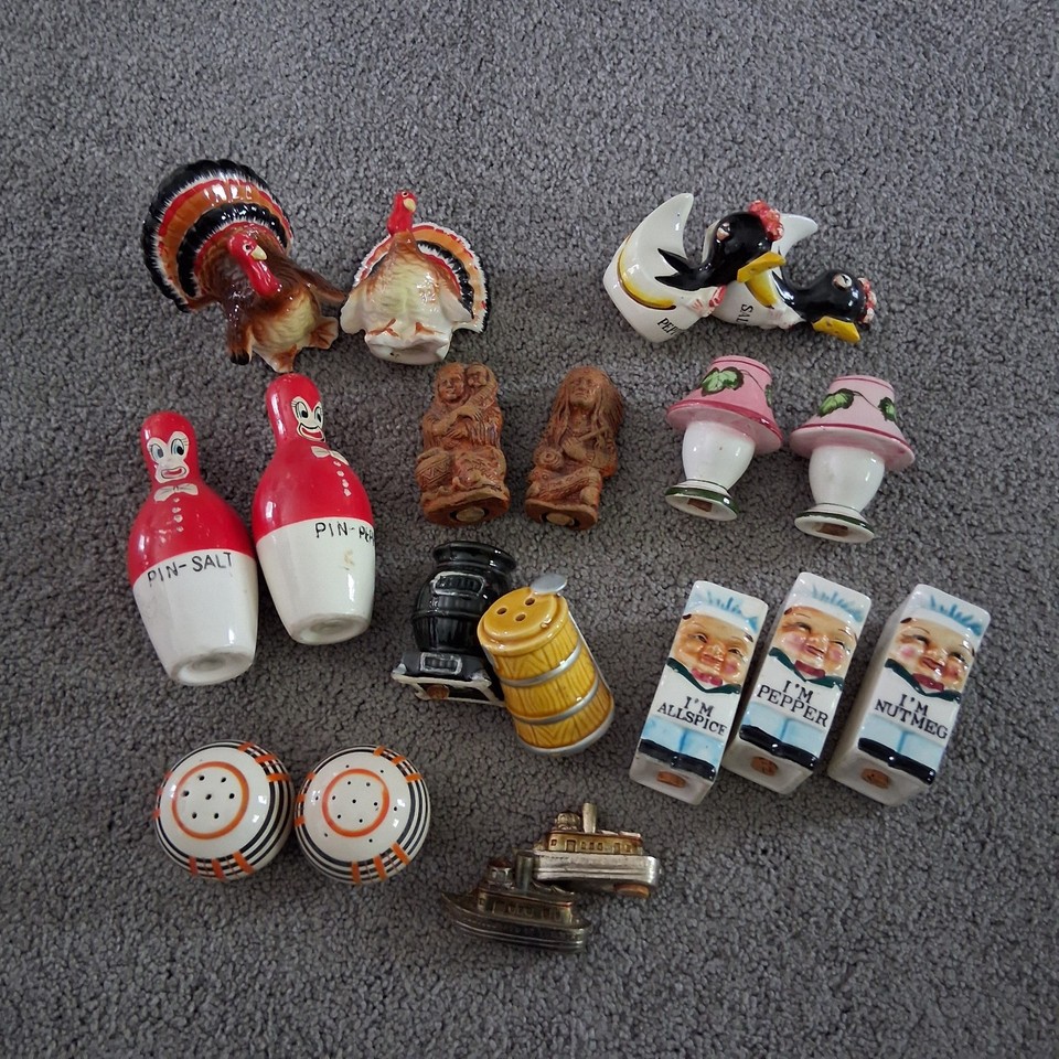 Nine pairs of vintage kitsch salt & pepper shakers plus a Niagara Falls souvenir — an instant curated shelf display for MCM and kitsch lovers.