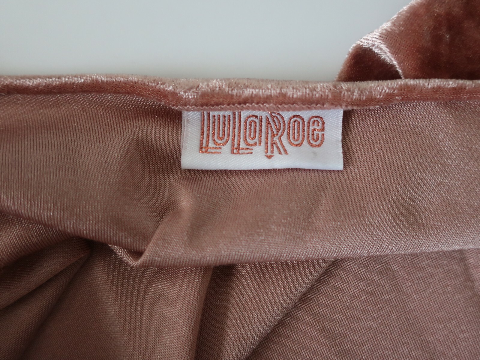Rose gold pink velvet cover up jacket with white tag reading “LuLaRoe” in red cursive text on inner collar.