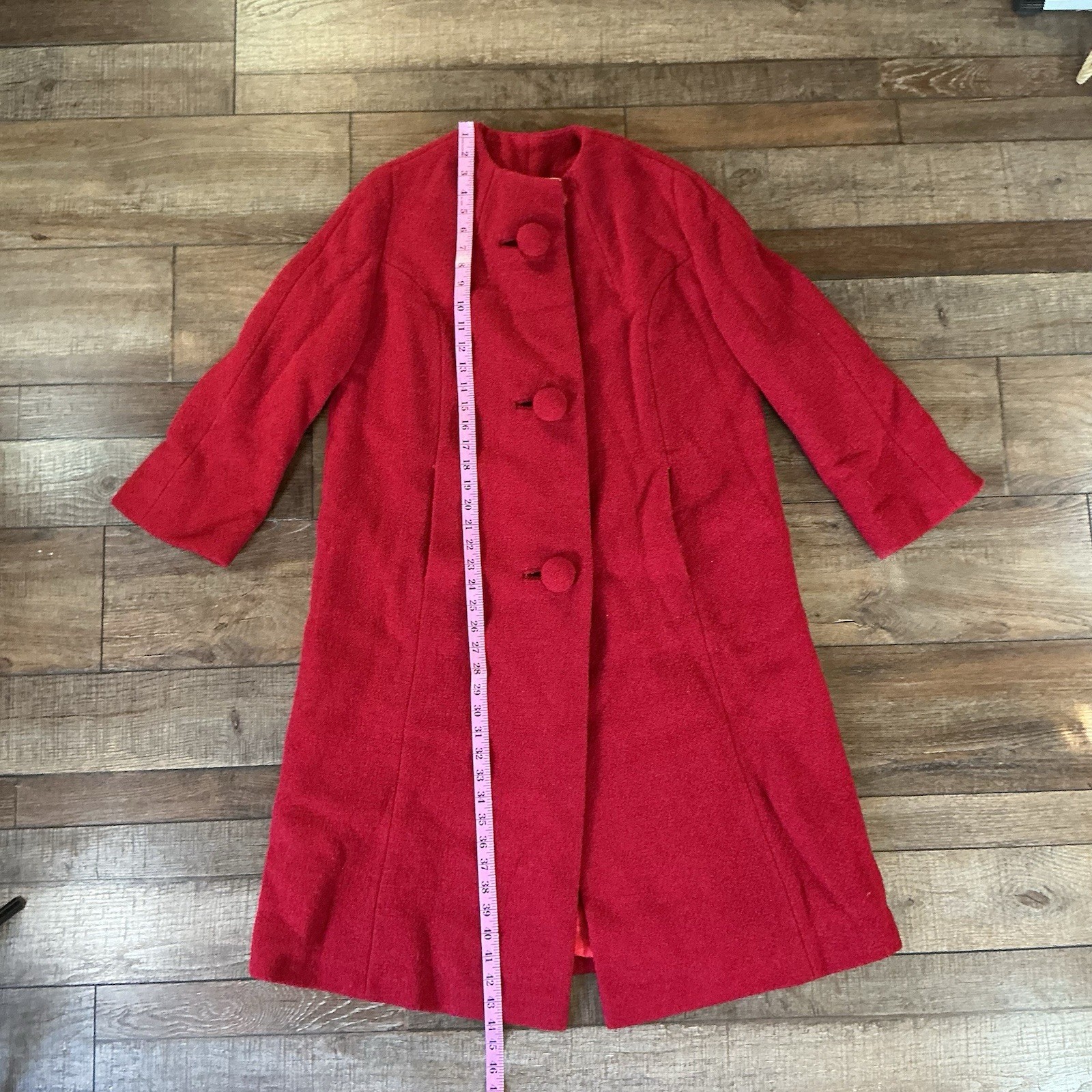 Bright red wool coat with round buttons, front view