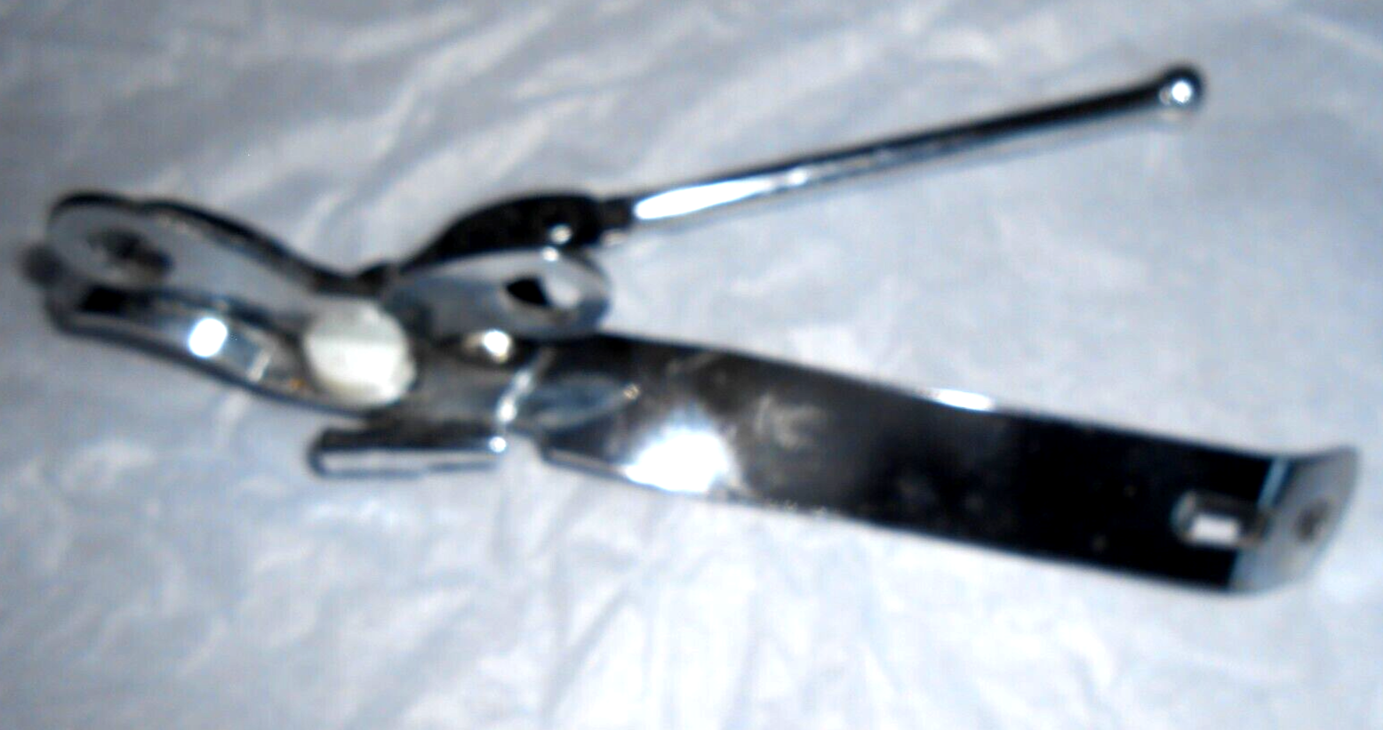 Chrome Can opener with punch and bottle opener-image