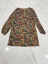 Vibrant floral dress with long sleeves. Perfect for any occasion.