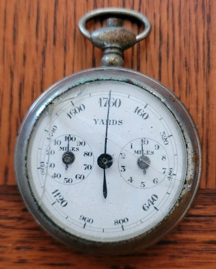 A fully working 1910 French mechanical pedometer with three gorgeous dials tracking yards and miles — wearable pre-digital fitness tech over a century old.