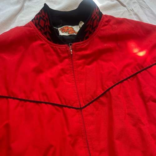 Red Vtg Comfy Casuals zip up jacket size M with black trim, front pocket, and white “Vtg Comfy Casuals” label on collar.