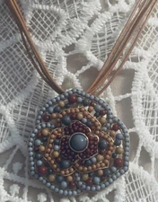 costome necklace on brown cord with enhancer