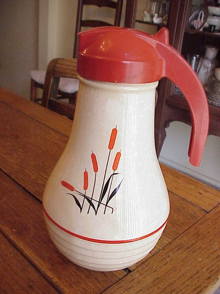CATTAILS, SEARS & ROEBUCK  9-1/2 IN, SYRUP PITCHER WITH RED TOP & HAN