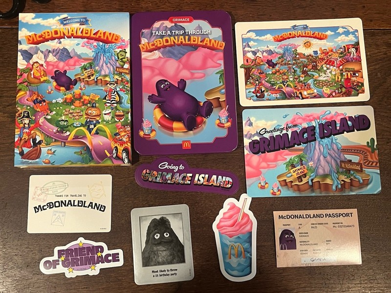 MCDONALD’S GRIMACE MCDONALDLAND ADULT HAPPY MEAL TIN Stickers Postcards Passport