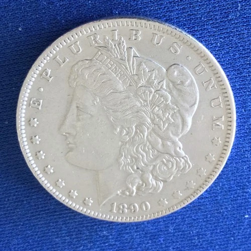 1890 Morgan Dollar having AU details and a nice coin with a nice shine.