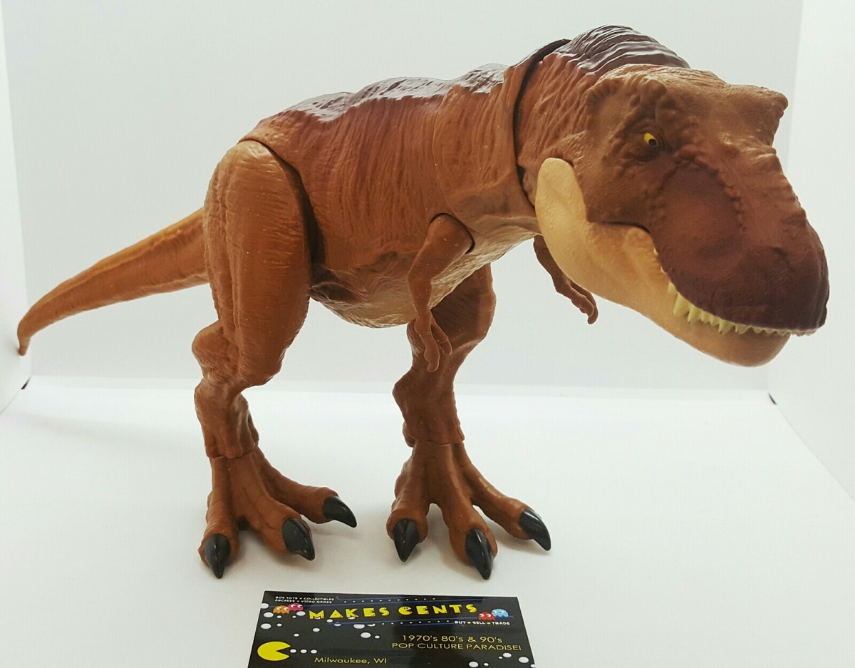 Jurassic Park T-Rex Toy With Bite Action Button On Top Of Jurassic Park T-Rex Toy With Bite Action Button On Top Of