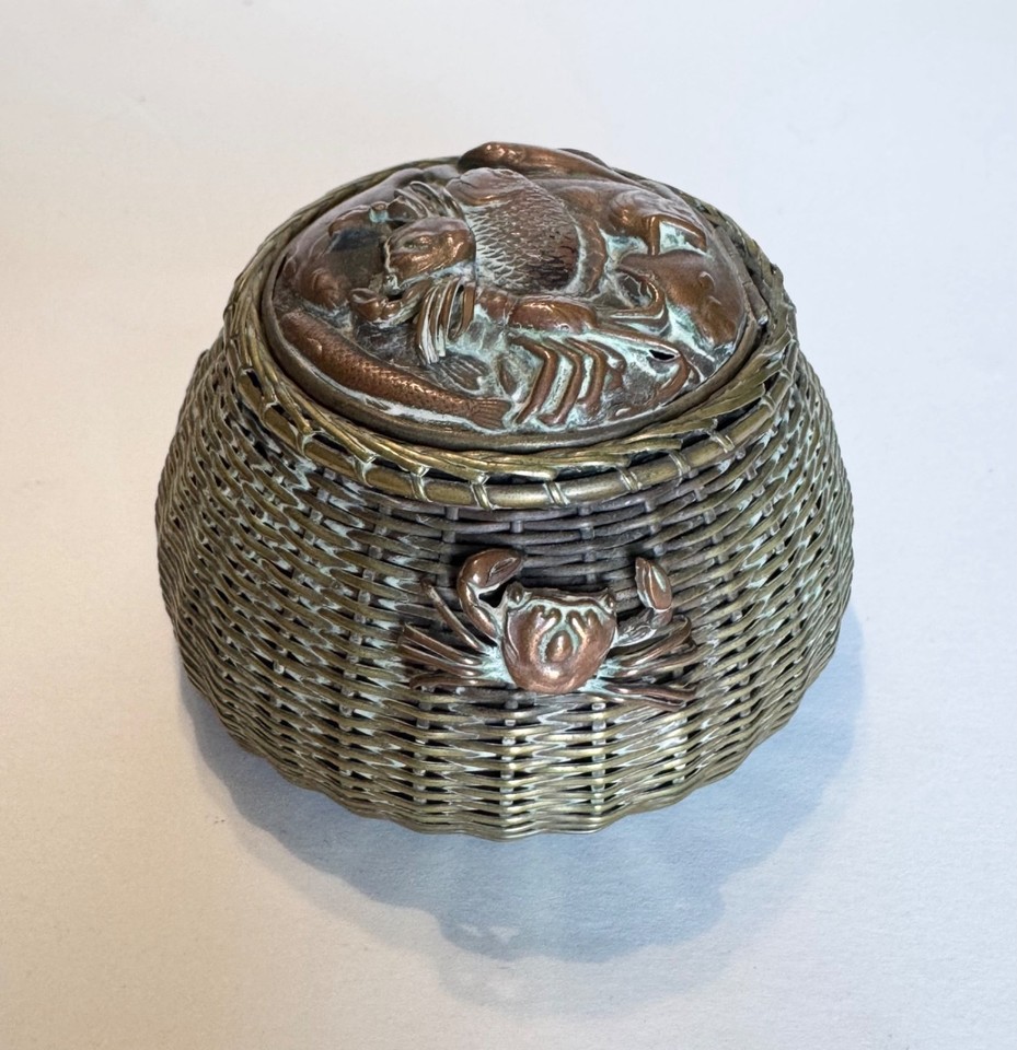 A sculptural antique brass inkwell crawling with a fish, crab, and lobster — basically a tiny nautical diorama you keep on your desk.