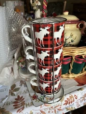 This is a set of 4 Buffalo check moose-patterned stacking mugs in metal rack.